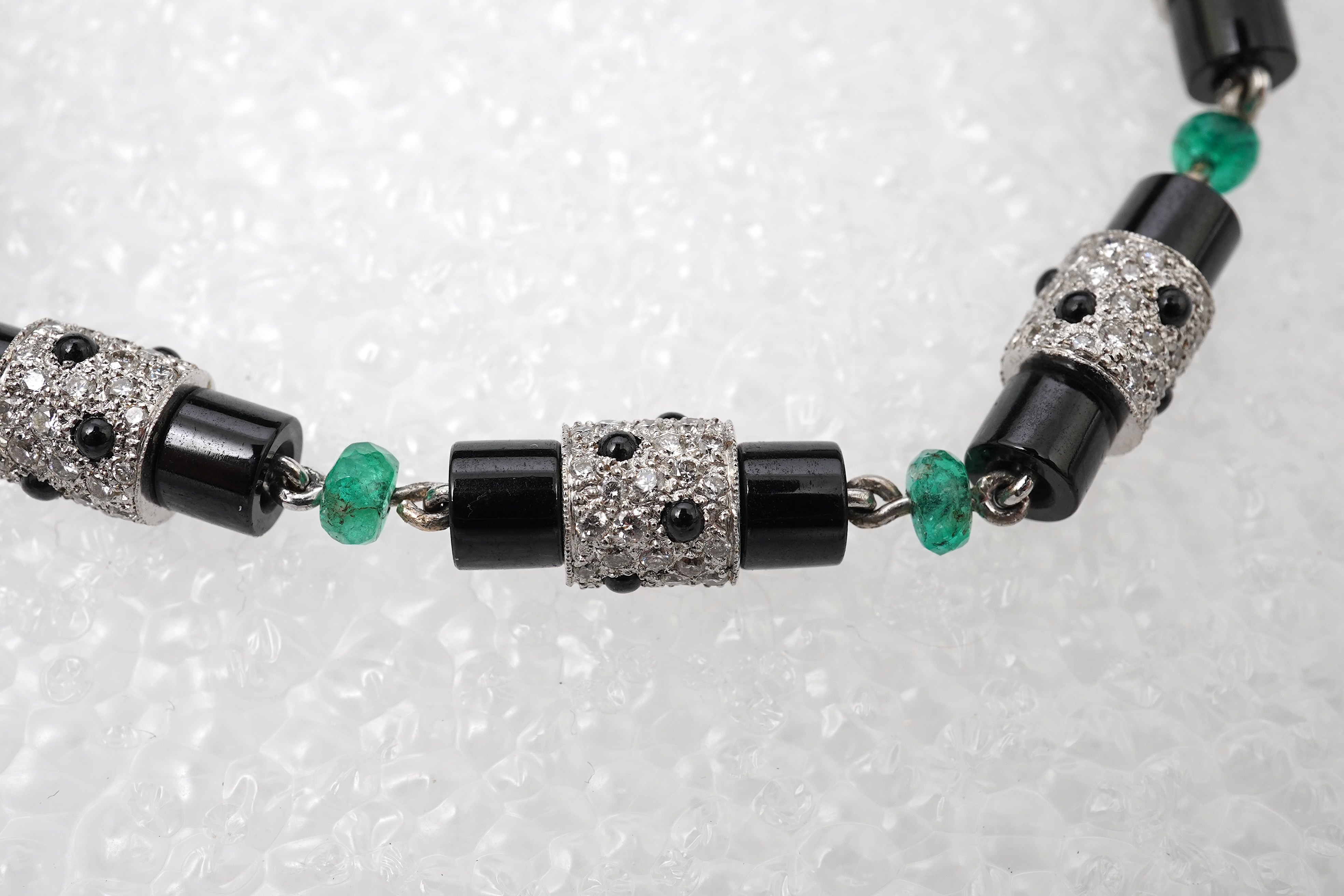 A stylish onyx, emerald and diamond bracelet